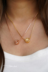 Circular studded initial necklace