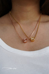 Circular studded initial necklace